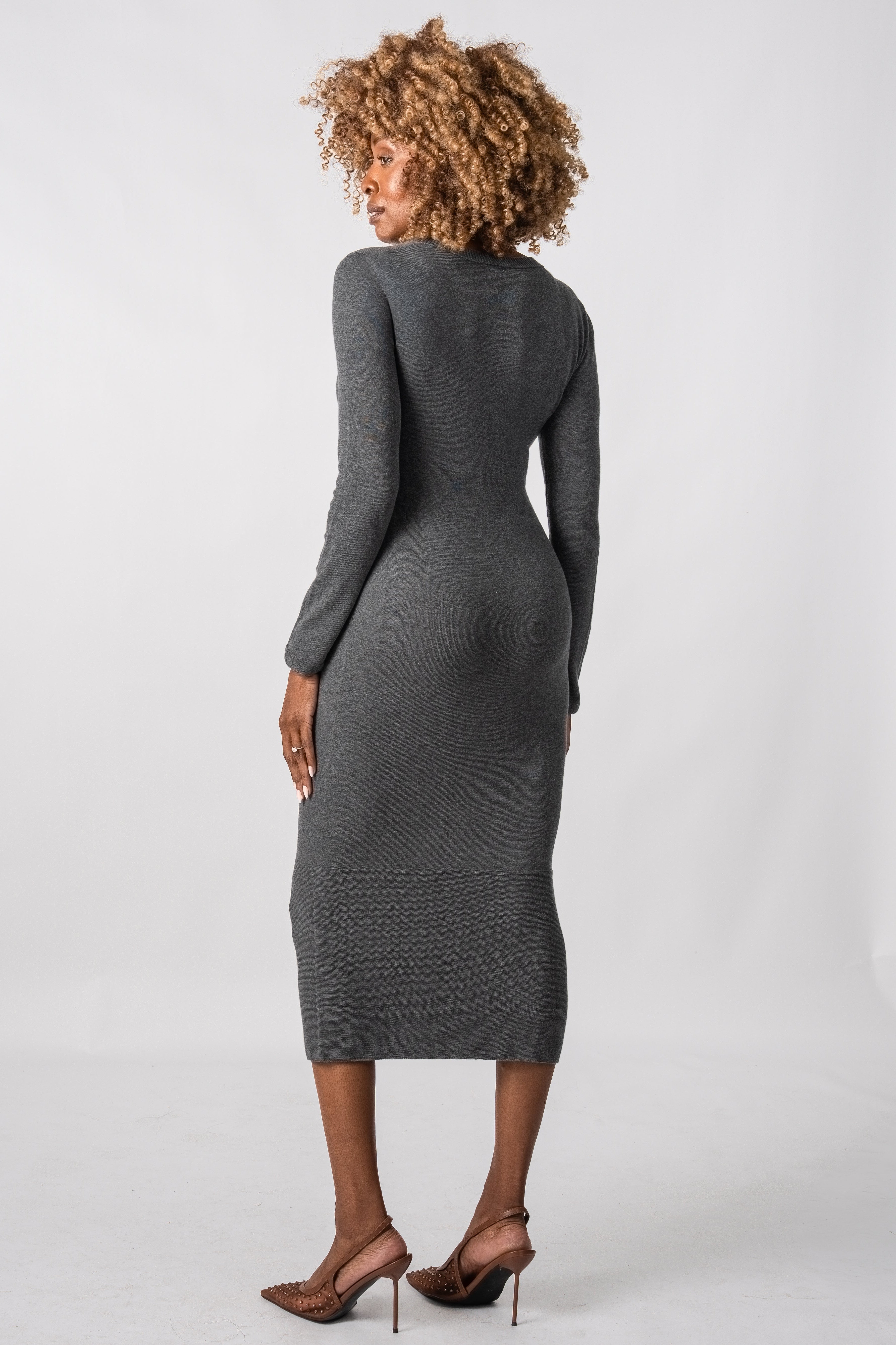 Woman wearing a gray dress against a white background