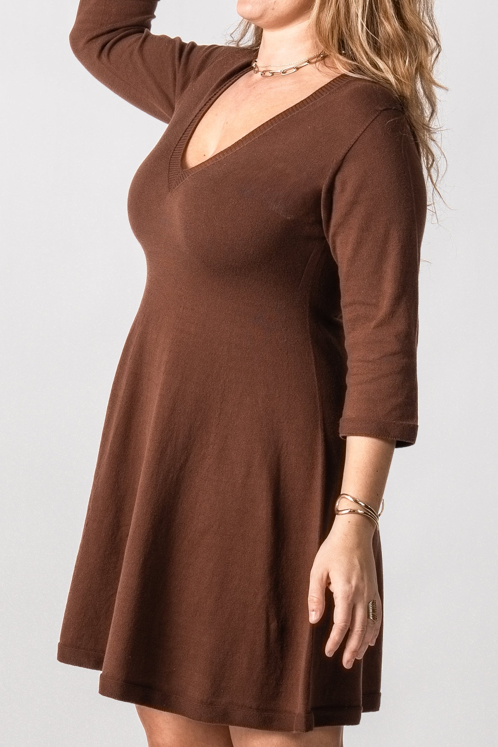 Woman wearing a brown dress on a white background