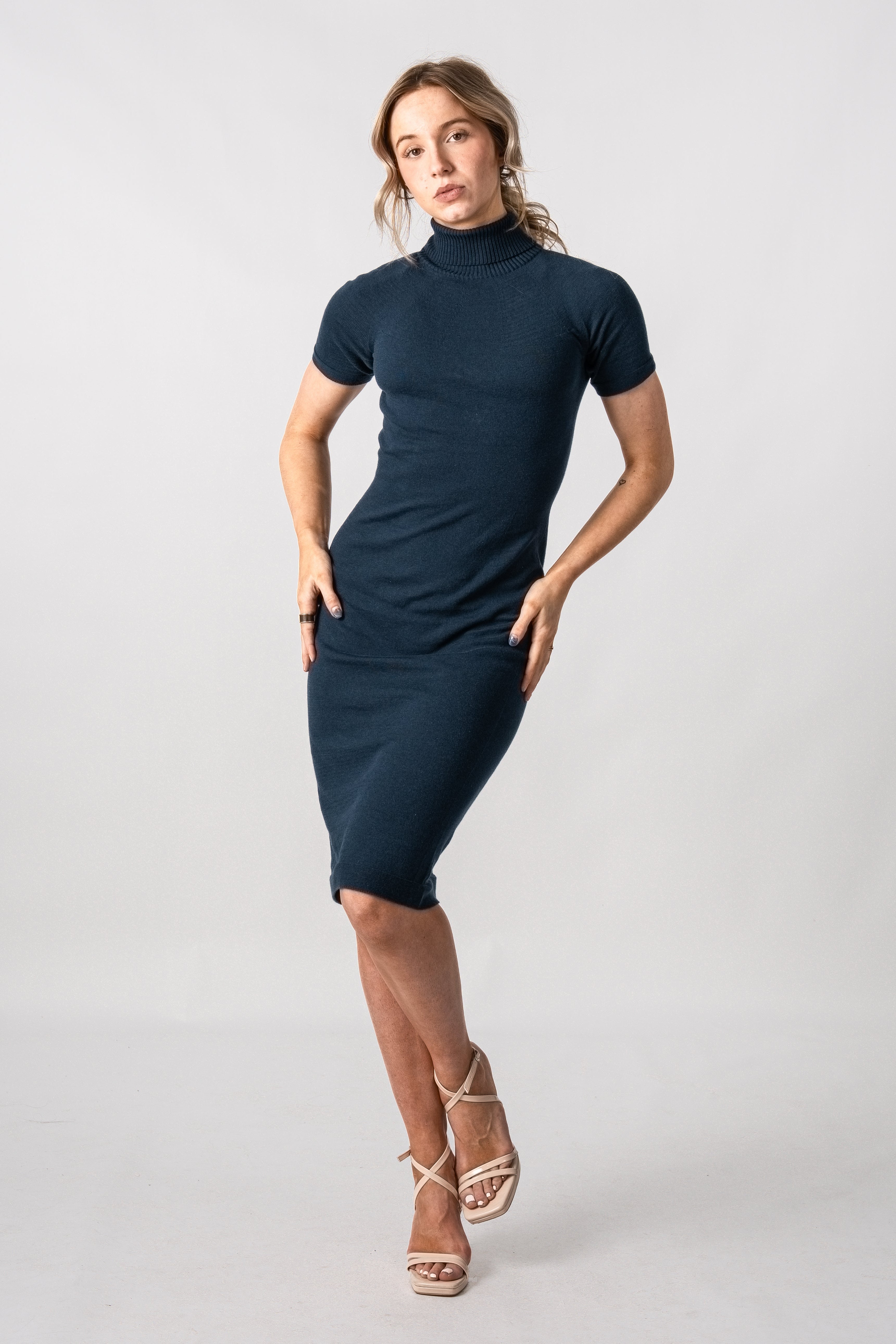 Woman wearing a navy blue dress on a white background