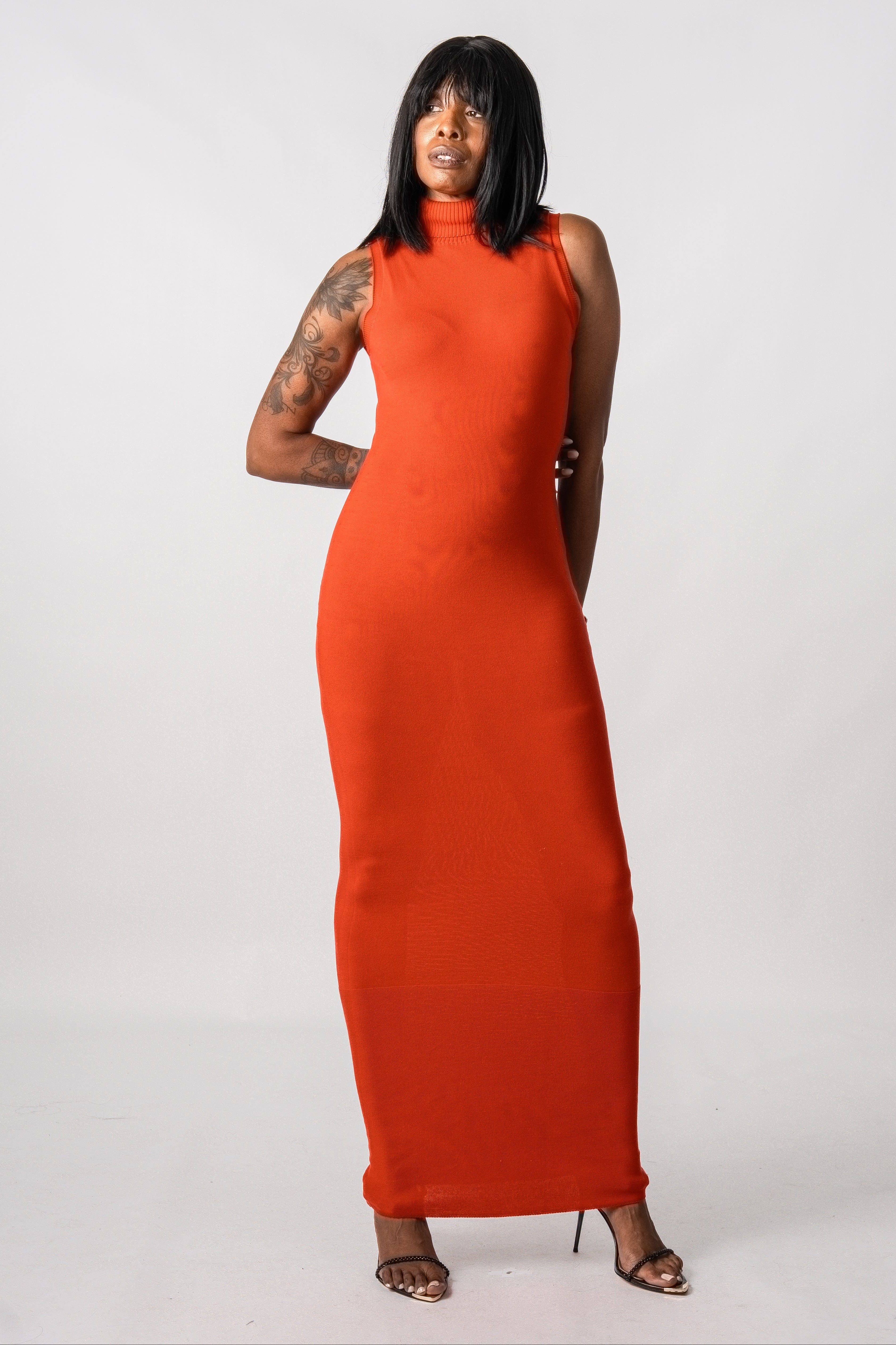Woman wearing an orange dress against a white background